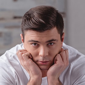 Man resting his face and chin on his hands