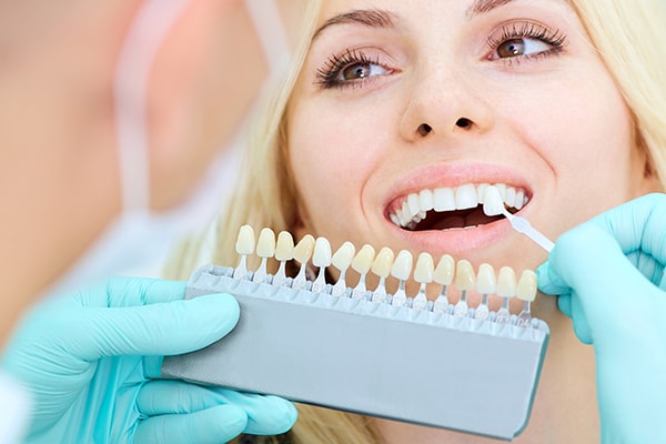 A female patient getting white teeth from teeth whitening